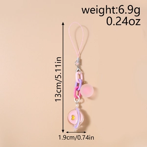 Detailed view of pink phone charm with round beads and a heart pattern planet pendant