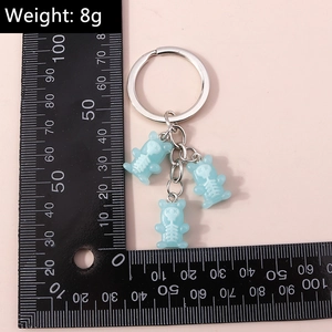 Detailed view of 8g light blue resin skull bear keychains with metal ring and size scale