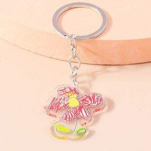 Creative acrylic flower keychain with graffiti sunflower print on light orange background