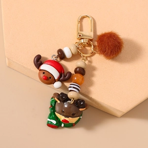 Detailed view of Christmas elk keychain with plush ball and festive beaded charms