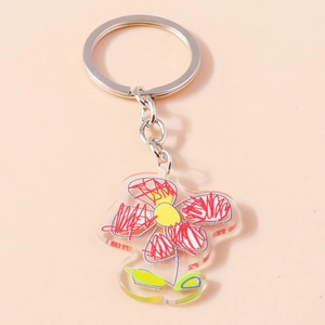 Artistic acrylic flower keychain with hand-drawn graffiti style on a soft pink background