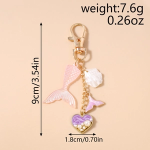 Detailed view of ocean theme keychain with pink fishtail shell and pearl heart charm
