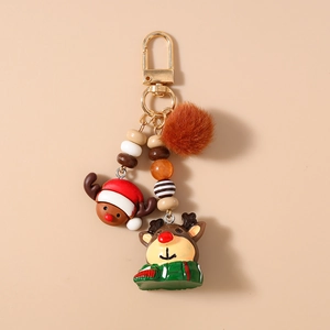 Detail of Christmas reindeer keychain with plush pompom and colorful beaded charm strap