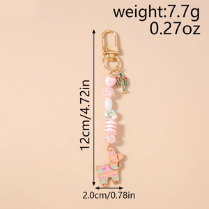Detail of beaded keychain with pink heart, cute alpaca pendant and cactus charm decoration