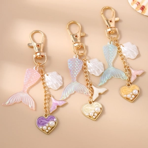 Mermaid tail keychain set with colorful shell pendants and pearl heart charms in gold finish