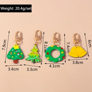 Detailed view of four Christmas keychains showing tree, wreath, and bell dimensions