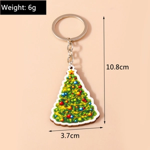Detail view of acrylic Christmas tree keychain with colorful baubles and metal ring