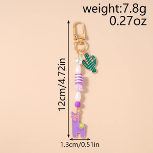 Detail of beaded keychain with green cactus and purple alpaca enamel charms for fashion decor