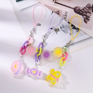 Detail view of colorful acrylic planet, candy and butterfly charms on chunky chain links