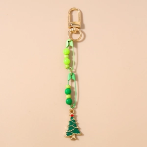 Detail view of a Christmas tree keychain with green beads and a golden lobster clasp