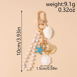 Detail showing ocean-themed keychain dimensions with pearls, starfish, and shells