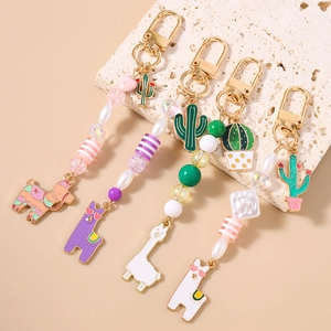 Fashionable cactus and alpaca beaded keychains with gold enamel finish and pearls