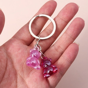 Detail view of cute purple and wine red gummy bear charms on a silver keychain