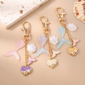 Chic mermaid tail keychains with pearl hearts and shells in pink purple and blue