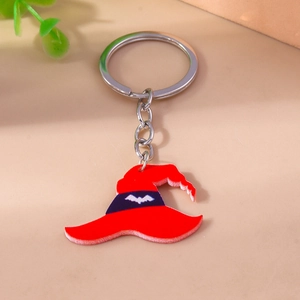 Detail of a red Halloween wizard hat keychain featuring purple stripe and white bat patterns
