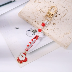 Detail of Christmas Santa keychain with gold paperclip pin and red beads accessory