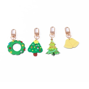 Set of four festive Christmas keychains featuring wreath bell and tree pendant designs