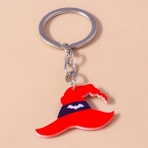 Detail of red acrylic witch hat keychain with purple band and bat pattern engraving