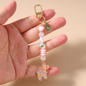 Close-up of beaded keychain with pink heart beads and cactus alpaca metal charms