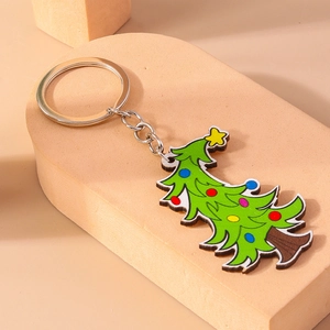 Detail of cartoon Christmas tree keychain with colorful dots and silver metal ring
