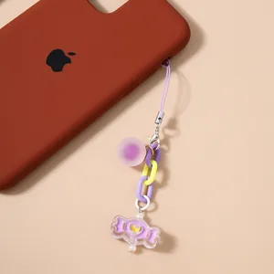 Detailed close-up of a purple candy-themed keychain with acrylic heart and chain links