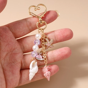 Detail of ocean-themed keychain with whale, starfish, shells, and macaron beads