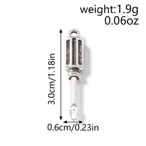 Detail view of a vintage silver screwdriver pendant with size and weight measurements