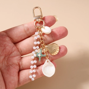 Detailed view of ocean style keychain with tassel pearls shells and starfish pendants