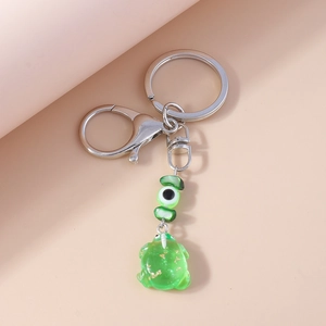 Creative frog eye keychain with green resin charm and gold foil details for bags