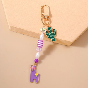 Macro view of cactus and llama charm keychain with colorful beads and gold lobster clasp