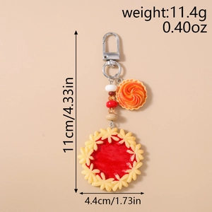 Detailed view of handmade beaded food keychain featuring strawberry pie and tart charms