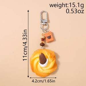 Detail of beaded simulated cookie keychain featuring almond and small bear biscuit charm