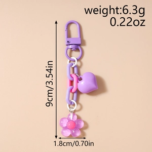 Macro detail of purple cherry blossom keychain with heart charm and size dimensions