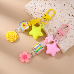 Detail of colorful resin beaded keychains featuring flowers, stars and cube beads