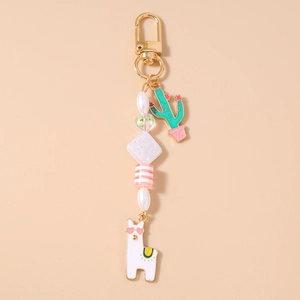 Detail of keychain with colorful beads, enamel cactus and alpaca charms on gold hook