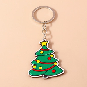Close-up of green Christmas tree keychain with colorful dots and silver metal ring