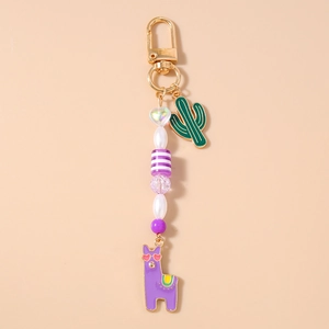 Detail of beaded keychain with purple llama pendant and green cactus charm