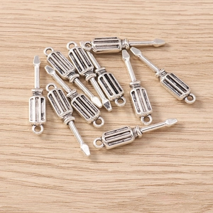 Macro detail of 10-piece set vintage silver screwdriver charms for DIY jewelry crafting