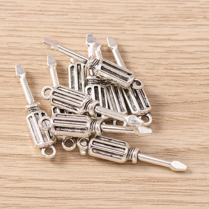 Macro view of silver-tone screwdriver charms for DIY jewelry and keychain making