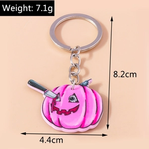 Pink Halloween pumpkin keychain with dagger detail, weight 7.1g and height 8.2cm