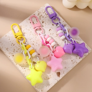 Detail of sweet star and heart charms keychain with resin beads and metallic clasp
