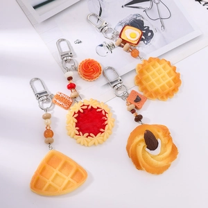 Handmade beaded keychain with realistic food pendants like waffle and strawberry tart