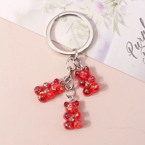 Detail of red resin bear keychain charms with sparkling glitter and silver metal ring