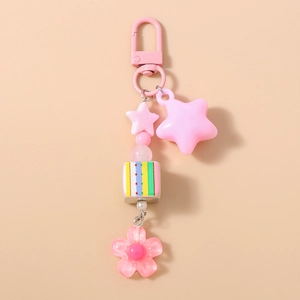 Detailed view of pink acrylic flower keychain with star charms and rainbow cube bead