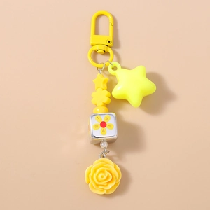 Detailed close-up of yellow beaded keychain featuring stars, flowers and sunflower cube