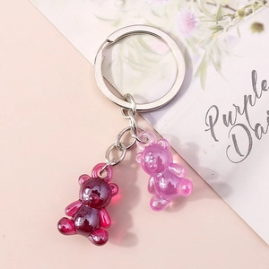 Detail of dual purple gummy bear charms on a silver keychain with translucent resin finish