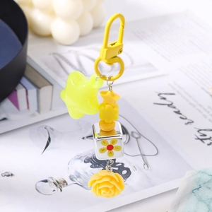 Detailed close-up of yellow flower bead and star charm on a fashion keychain accessory