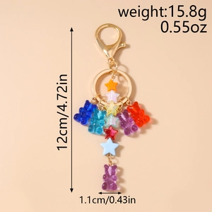 Detail view of colorful resin bear and star keychain charms with dimension and weight labels
