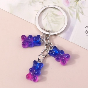 Detail of blue purple gradient resin bear keychain with glitter in silver metal ring