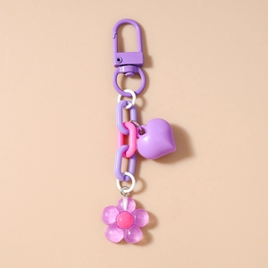 Detail of purple and pink heart and flower keychain charms with metal lobster clasp